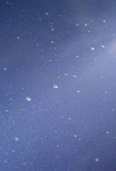 Dried water spots on a dark car panel