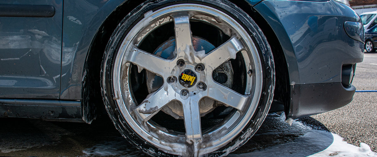 Wheel being cleaned before the rest of the car is washed
