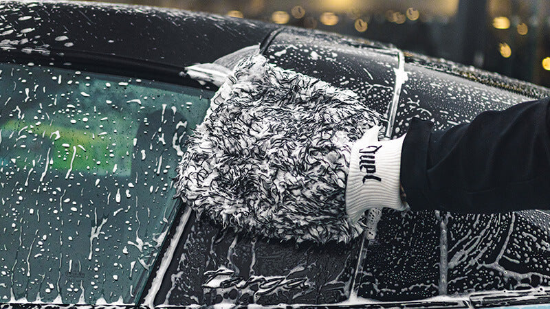 Microfibre wash mitt on soapy panel — safe contact washing technique