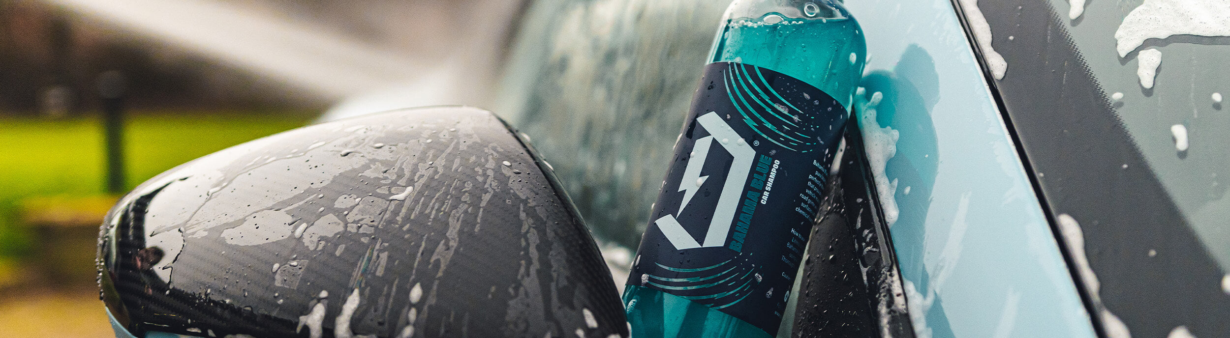 Bahama Blue car shampoo resting on a wet car door