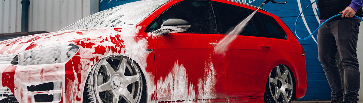 Snow foam being pressure washed off a car — showing clean rinse behaviour after correct dilution