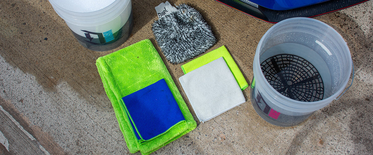 Flat lay starter microfibre kit — wash mitt, drying towel, general cloths, glass cloth neatly arranged