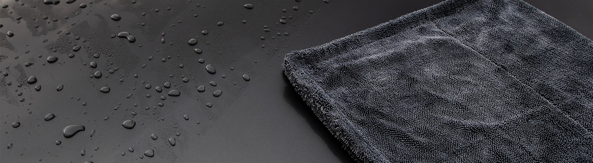 Twisted loop drying towel being used on a freshly washed car panel