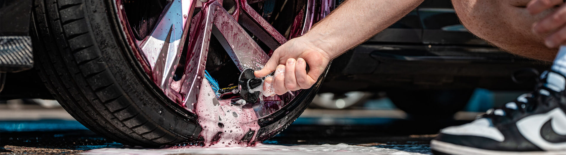 Applying iron fallout remover to a car as part of vehicle decontamination