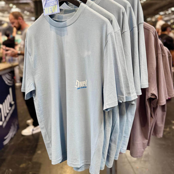 Duel Autocare MIB Oversized T-Shirt front sky blue hung on a rail