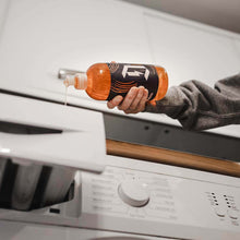 Duel Laundry being poured into detergent draw in washing machine