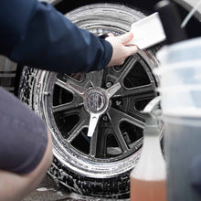 Tyre being cleaned with Duel Cleanse and tyre scrubbing brush